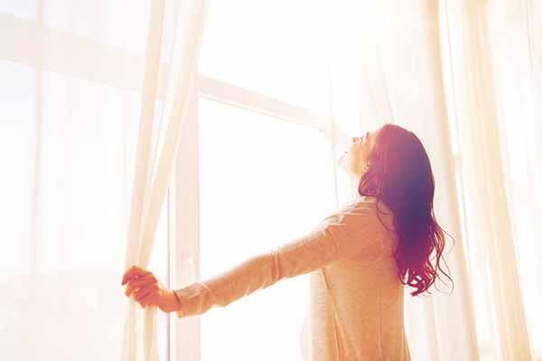 Happy woman looking at clean windows